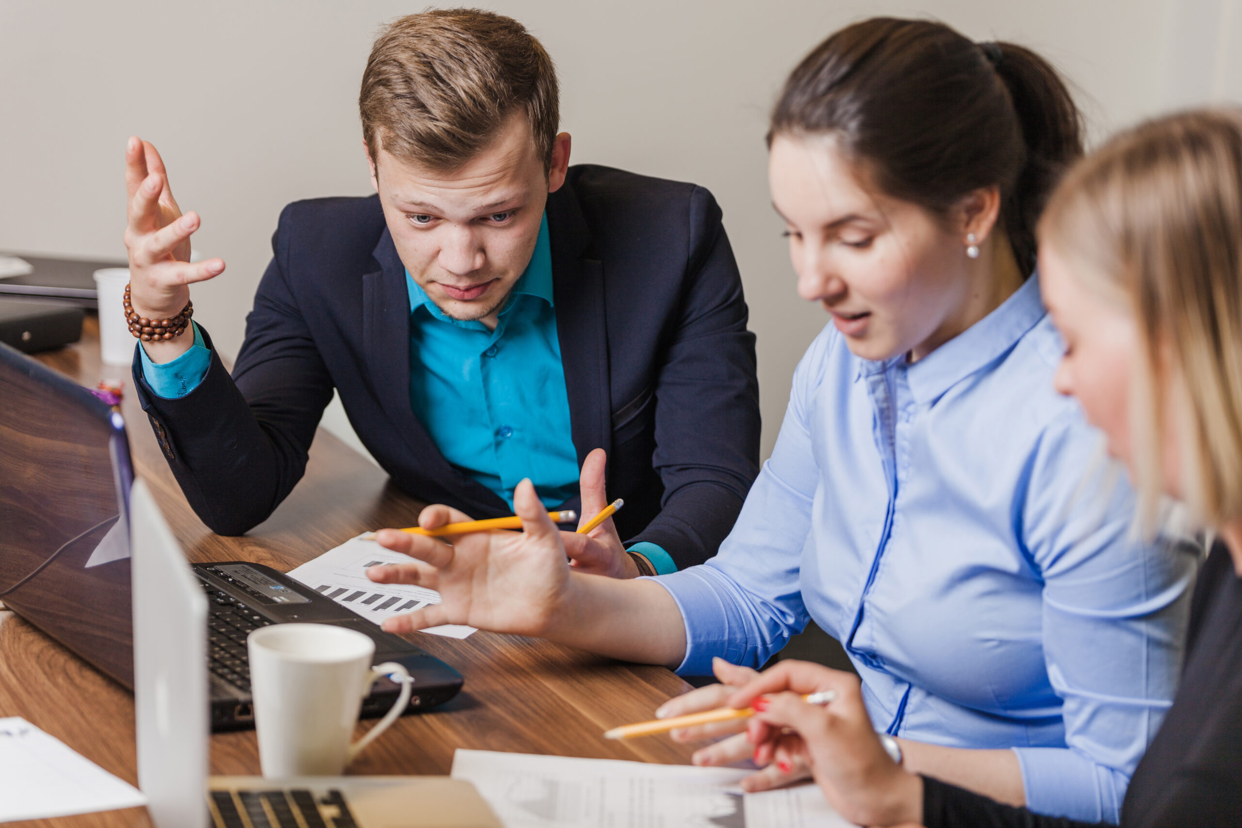 office-employees-sitting-desk-talking